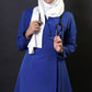Extra long scrub top with long sleeves in royal blue perfect for women in healthcare! This top has a 36 inch length and flare top design for a modest look. It's also hijabi friendly, so you can feel comfortable and cover the lower bottom.